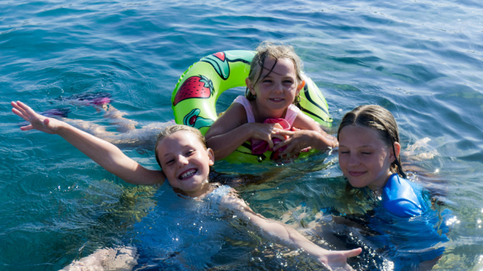 The kids having fun in the sea at Latchi Beach