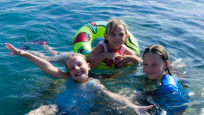 The kids having fun in the sea at Latchi Beach