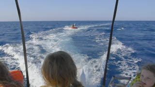 Lucy having a Tube Ride being towed by a speedboat